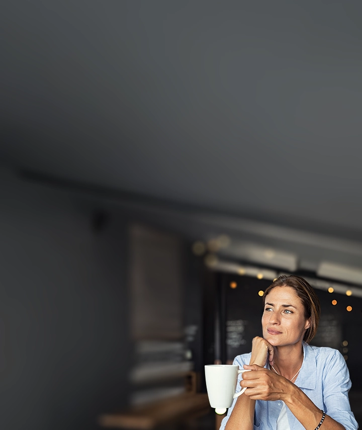 woman in kitchen with cup of espresso
